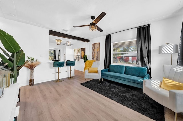 living room with ceiling fan with notable chandelier and light wood-type flooring