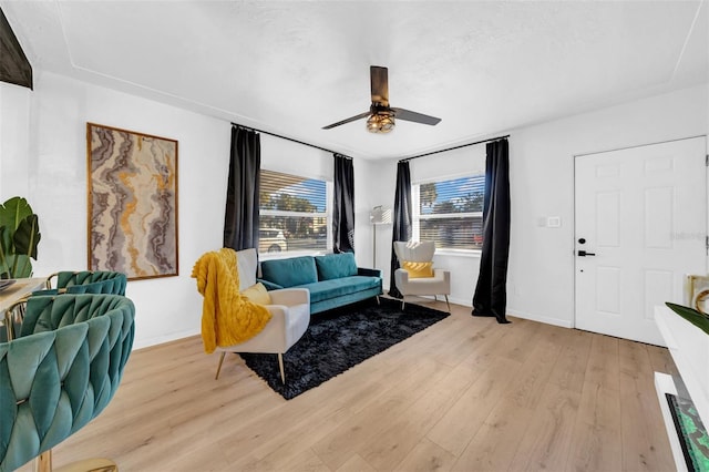 living room featuring ceiling fan and light wood-type flooring