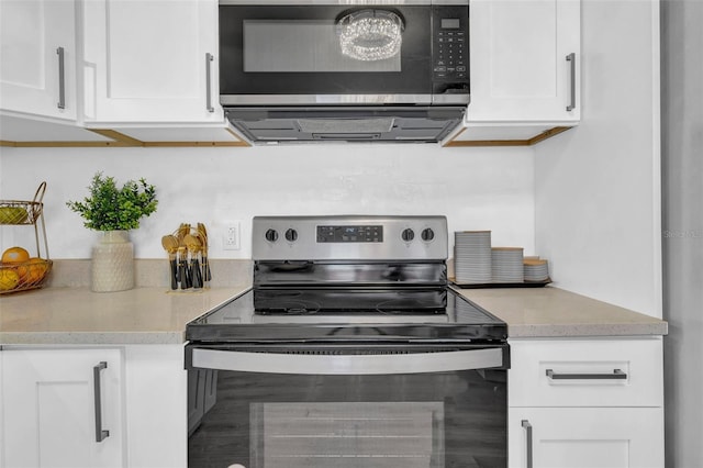 kitchen featuring white cabinets and appliances with stainless steel finishes