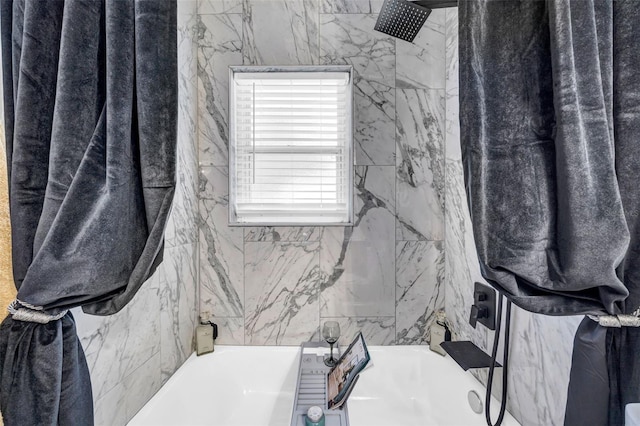 bathroom featuring tile walls and tiled shower / bath combo