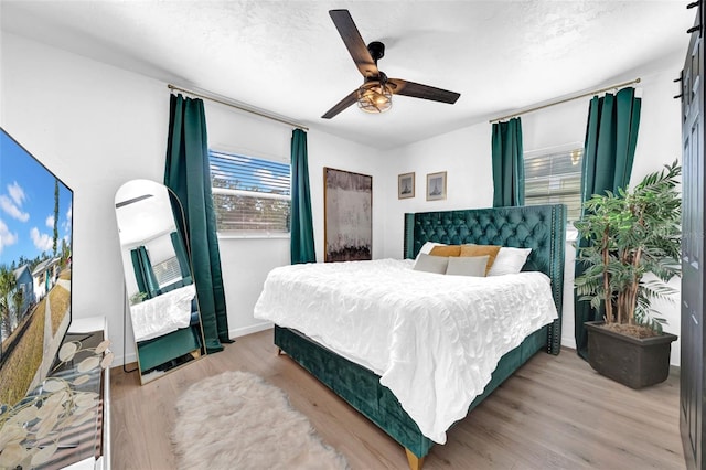 bedroom with ceiling fan and light hardwood / wood-style floors