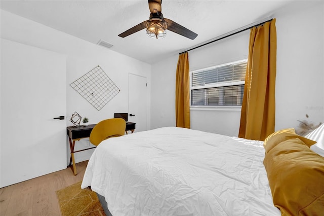 bedroom with hardwood / wood-style floors and ceiling fan