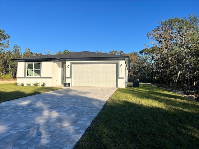 view of front of property with a front yard and a garage