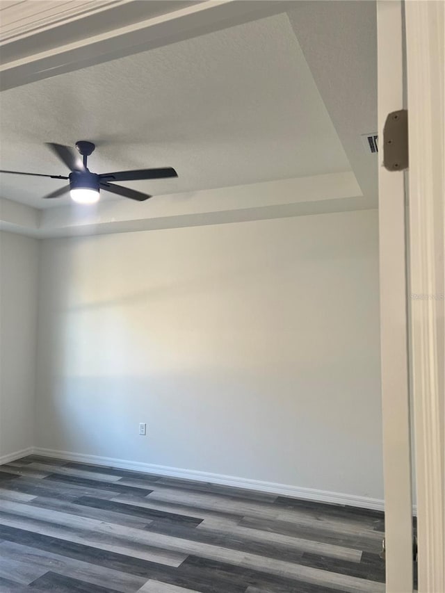 spare room featuring ceiling fan and dark hardwood / wood-style flooring