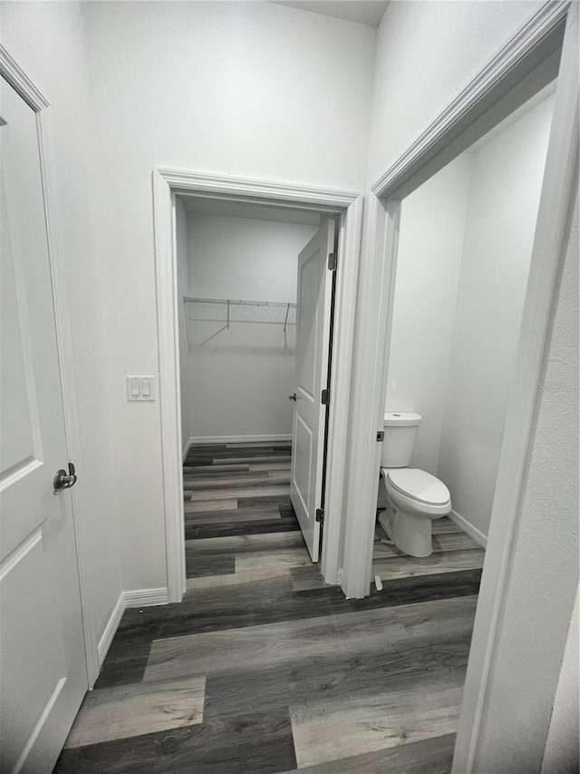 bathroom with hardwood / wood-style flooring and toilet