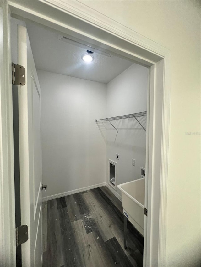 laundry room with dark hardwood / wood-style floors, electric dryer hookup, and sink