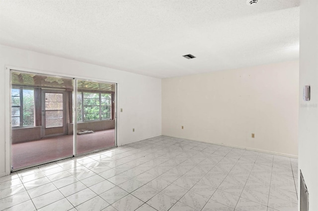 empty room featuring a textured ceiling