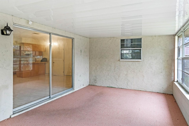 unfurnished sunroom featuring lofted ceiling