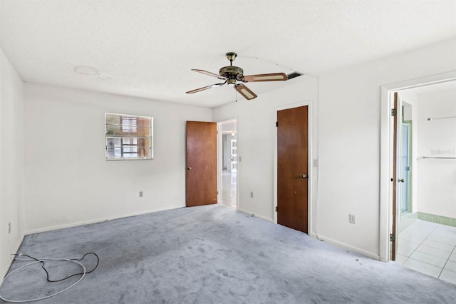 interior space featuring light carpet, a textured ceiling, and ceiling fan