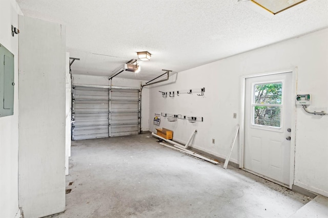 garage with electric panel and a garage door opener