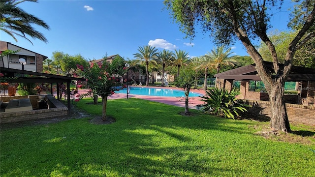 view of pool with a yard