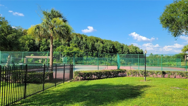 view of sport court with a yard