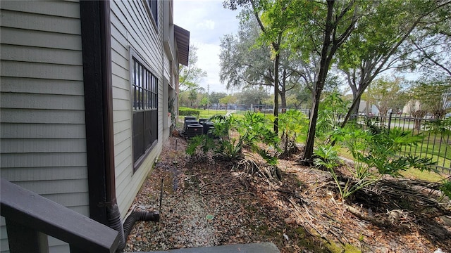 view of yard featuring central air condition unit