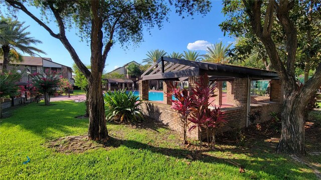 exterior space featuring a fenced in pool and a front yard