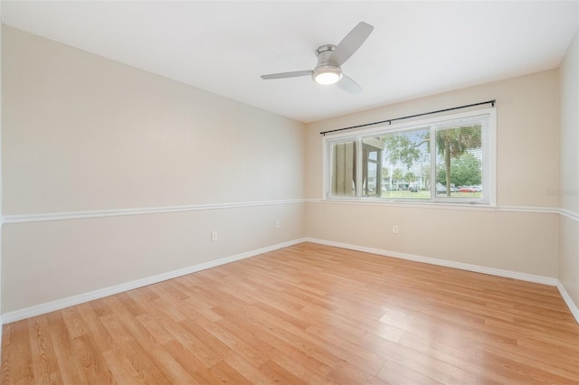 spare room featuring light wood-type flooring and ceiling fan