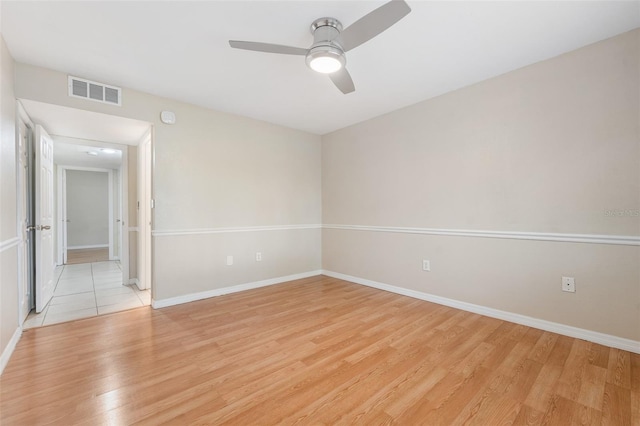 empty room with light wood-type flooring and ceiling fan