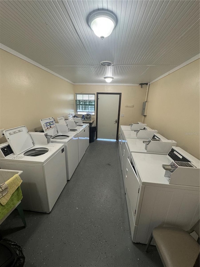 laundry room featuring washer and clothes dryer and crown molding