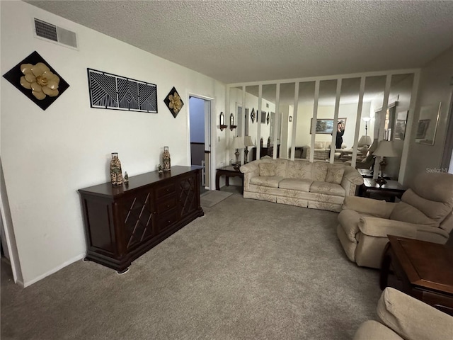 carpeted living room featuring a textured ceiling