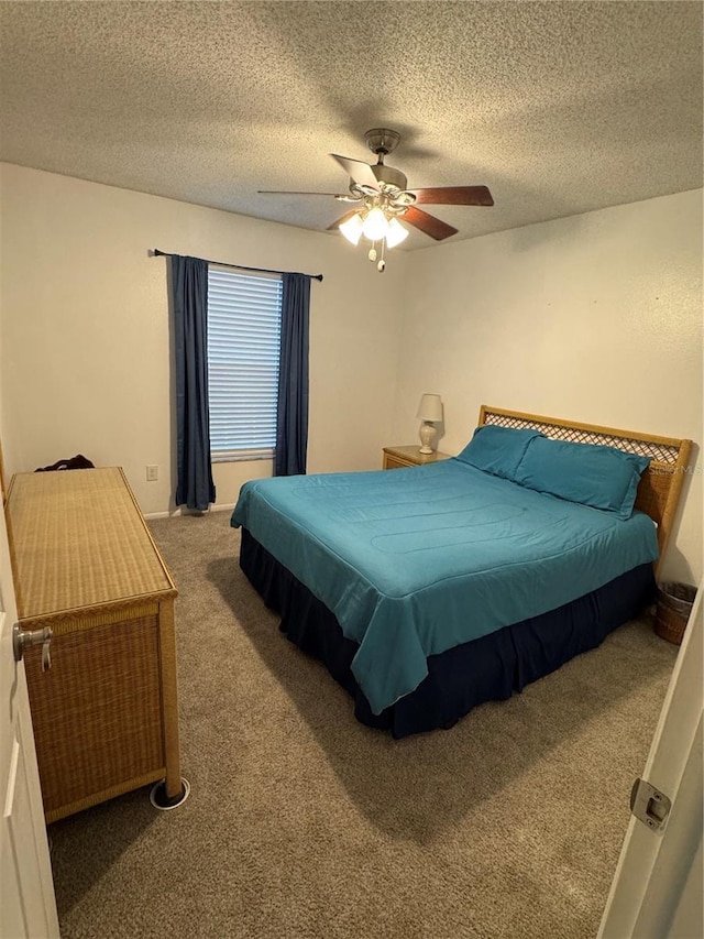 bedroom featuring carpet flooring, ceiling fan, and a textured ceiling