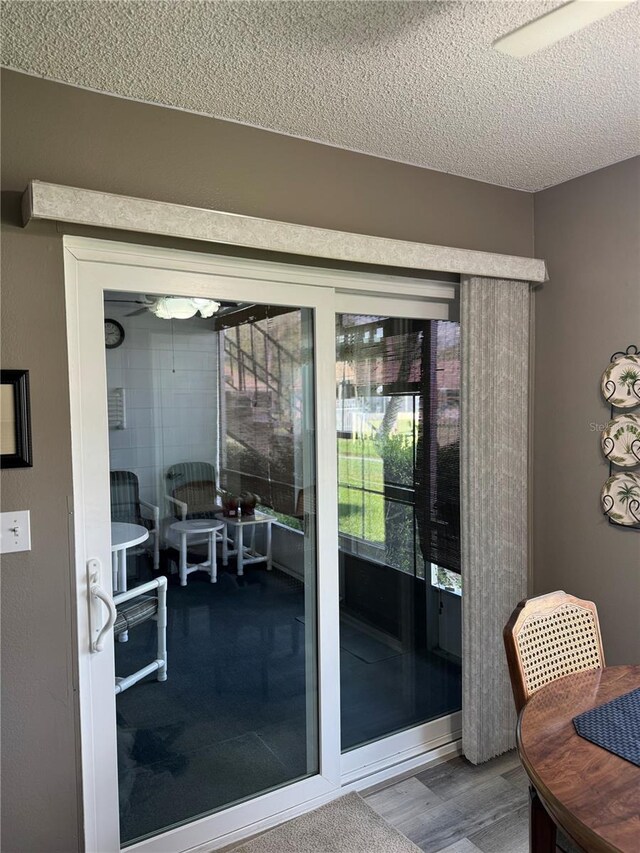 entryway with hardwood / wood-style floors and a textured ceiling