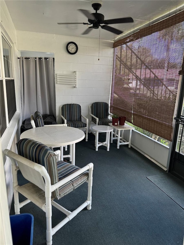 sunroom / solarium featuring ceiling fan