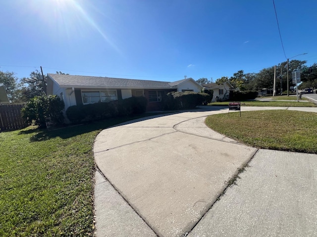 ranch-style home with a front lawn