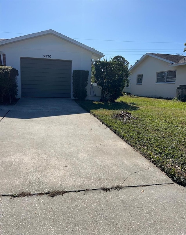 exterior space featuring a yard and a garage