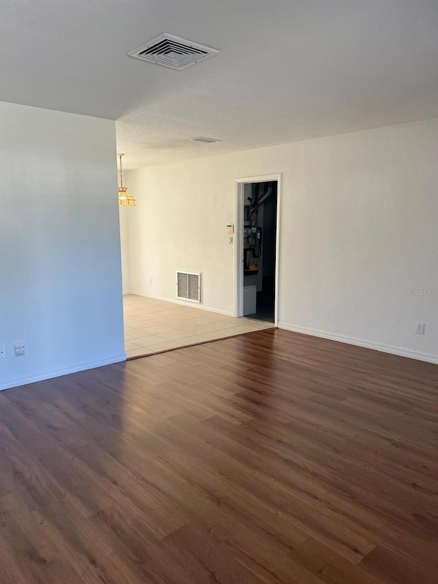 spare room with dark hardwood / wood-style flooring