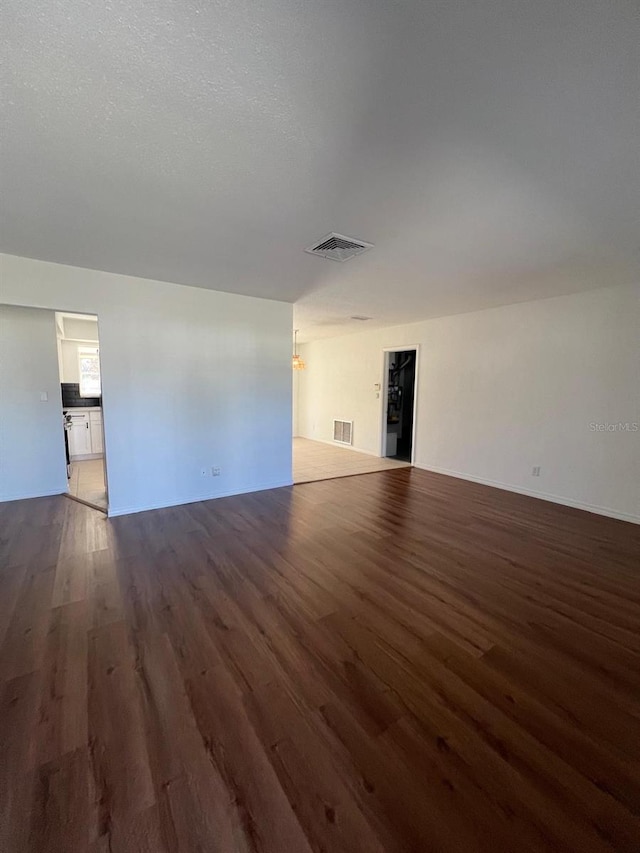 unfurnished living room featuring dark hardwood / wood-style flooring