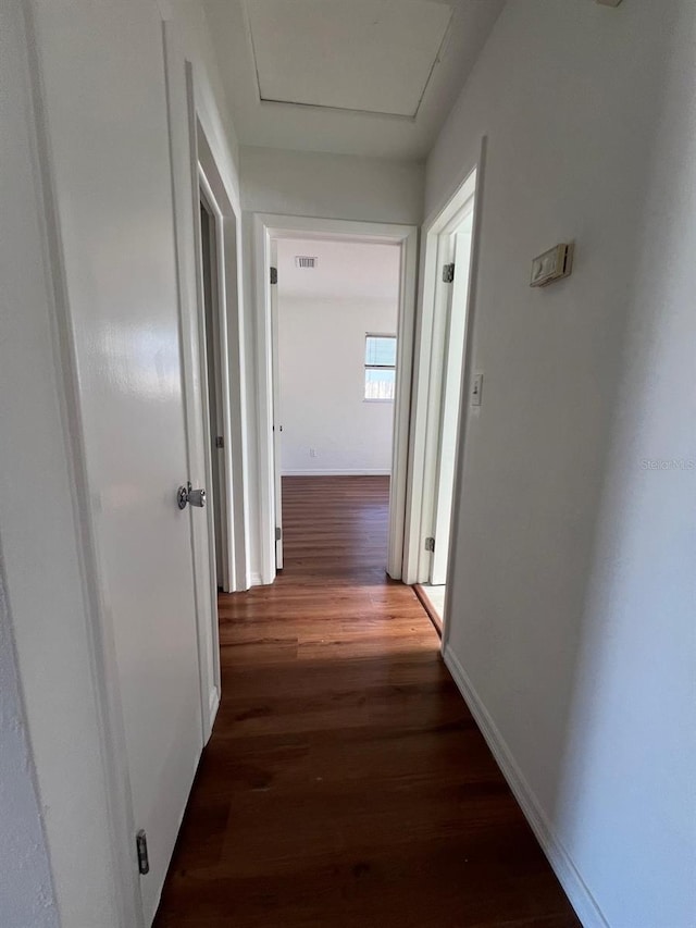 hallway with dark hardwood / wood-style floors