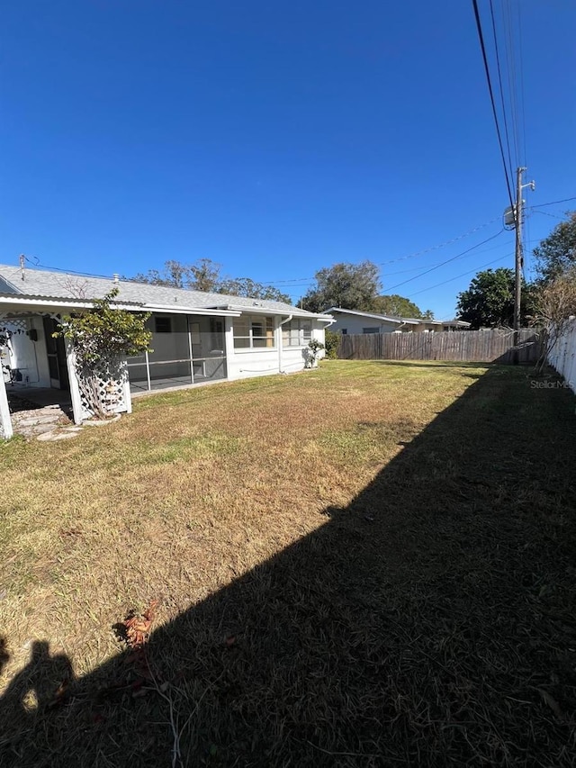 view of yard with a sunroom