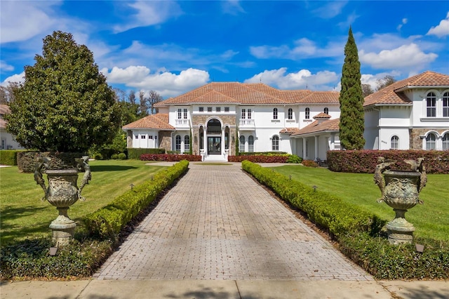 mediterranean / spanish-style house featuring a front yard