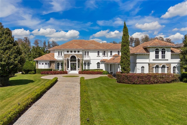 mediterranean / spanish-style house with a front yard