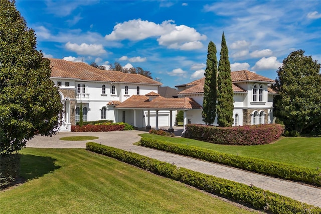 back of property with a yard and a garage