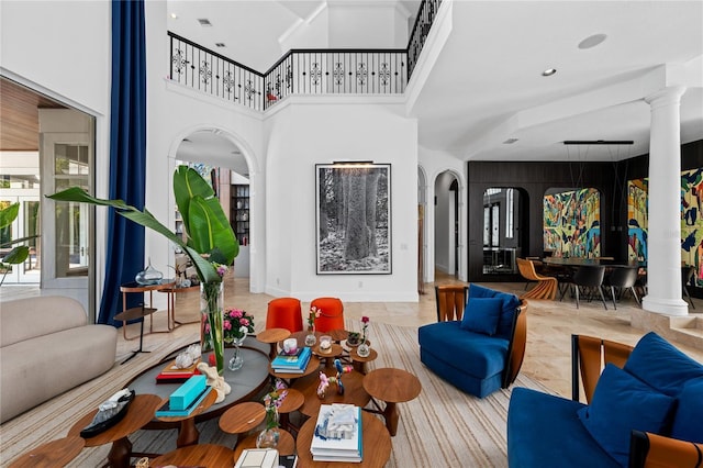 living room with a towering ceiling and light tile patterned flooring