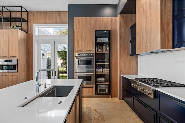 kitchen featuring a textured ceiling, sink, and appliances with stainless steel finishes