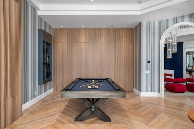 rec room with light parquet flooring, wood walls, and billiards