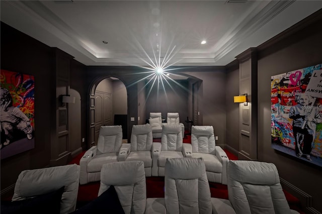 cinema with a raised ceiling and crown molding