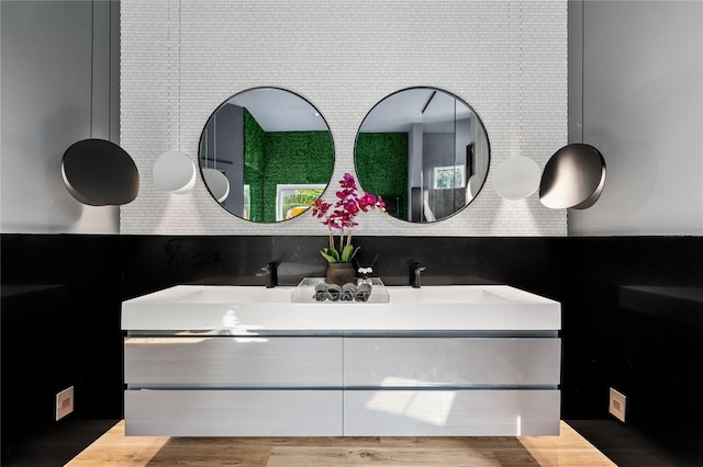 bathroom featuring tasteful backsplash, vanity, and wood-type flooring