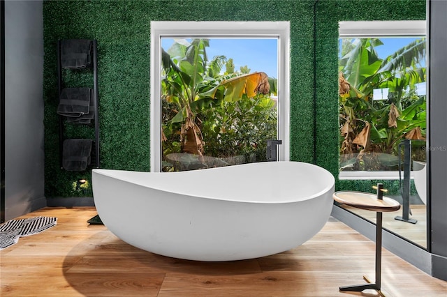 bathroom featuring hardwood / wood-style floors and a tub