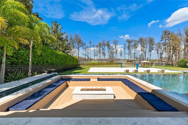 view of pool featuring a fire pit and a yard