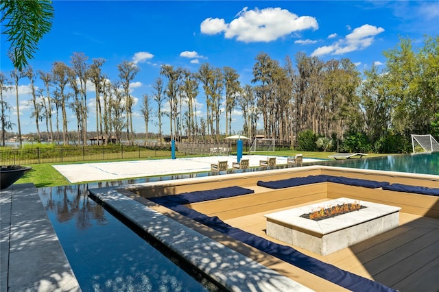 view of pool with an outdoor fire pit