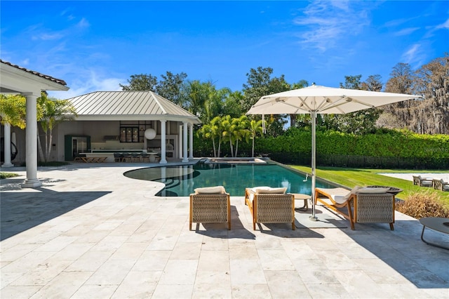 view of pool featuring outdoor lounge area and a patio