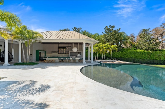 view of pool featuring exterior fireplace and a patio area