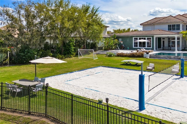 view of community featuring volleyball court and a yard