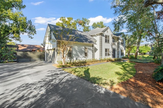 view of front facade with a garage and a front lawn