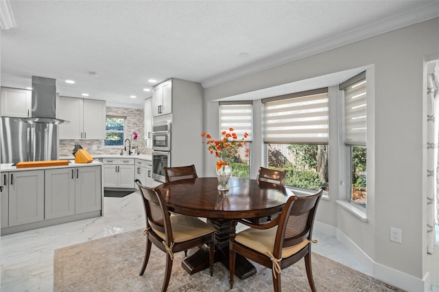 dining space with a textured ceiling and ornamental molding