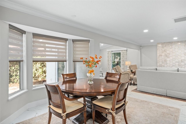 dining space with crown molding