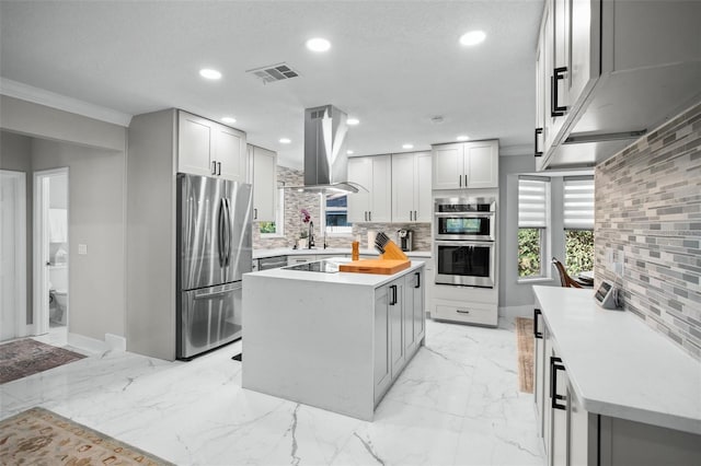 kitchen with island range hood, a textured ceiling, tasteful backsplash, a kitchen island, and stainless steel appliances