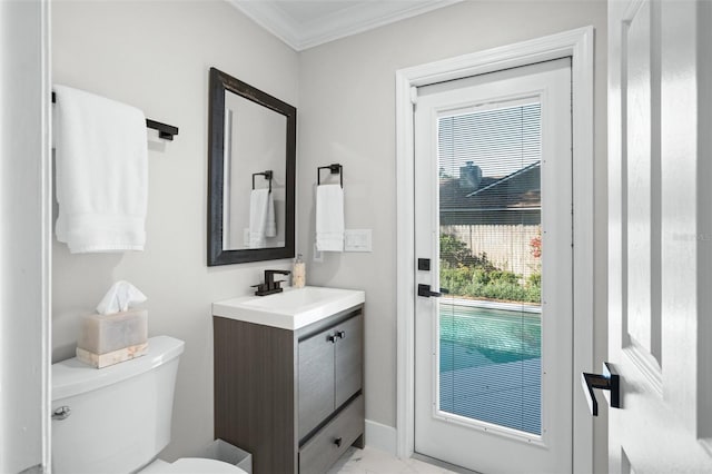 bathroom with vanity, toilet, and ornamental molding